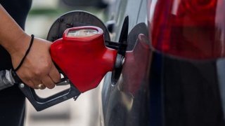 Brie Olootu pumps gas at an Exxon Mobil gas station on June 09, 2022 in Houston, Texas.