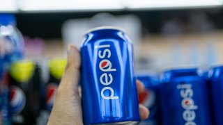 A customer holds a can of Pepsi beverage at a shopping mall on March 9, 2022 in Shaoxing, Zhejiang Province of China.