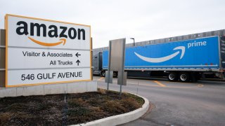 An Amazon Prime truck passes by a sign