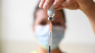 FILE - A health professional prepares a dose of a monkeypox vaccine at the Edison municipal vaccination centre in Paris Wednesday July 27, 2022.