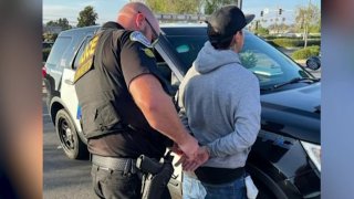 Sean Richter is seen being taken into custody in a photo posted on Facebook by Oceanside Police.