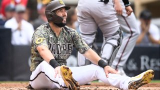 SAN DIEGO, CA β JUNE 17: Eric Hosmer #30 of the San Diego Padres looks up after being tagged out at the plate by Jose Herrera #36 of the Arizona Diamondbacks during the second inning of a baseball game July 17, 2022 at Petco Park in San Diego, California. (Photo by Denis Poroy/Getty Images)