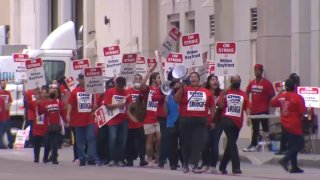 A few dozen hotel union workers strike outside the San Diego Bayfront Hotel on July 20, 2022.