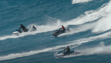 Jet skis tow surfers out of a wave in O’ahu, Hawai’i in this undated image. (Courtesy: “Big Wave Guardians”/Marty Hoffman in association with MacGillivray Freeman Films)