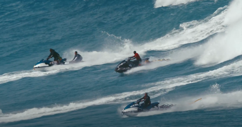 Jet skis tow surfers out of a wave in O’ahu, Hawai’i in this undated image. (Courtesy: “Big Wave Guardians”/Marty Hoffman in association with MacGillivray Freeman Films)
