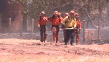 Fire crews at the scene of a brush fire near the Ramona Airport on July 19, 2022.