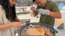 Kevin and Kimberly Leong learn how to shuck oysters.