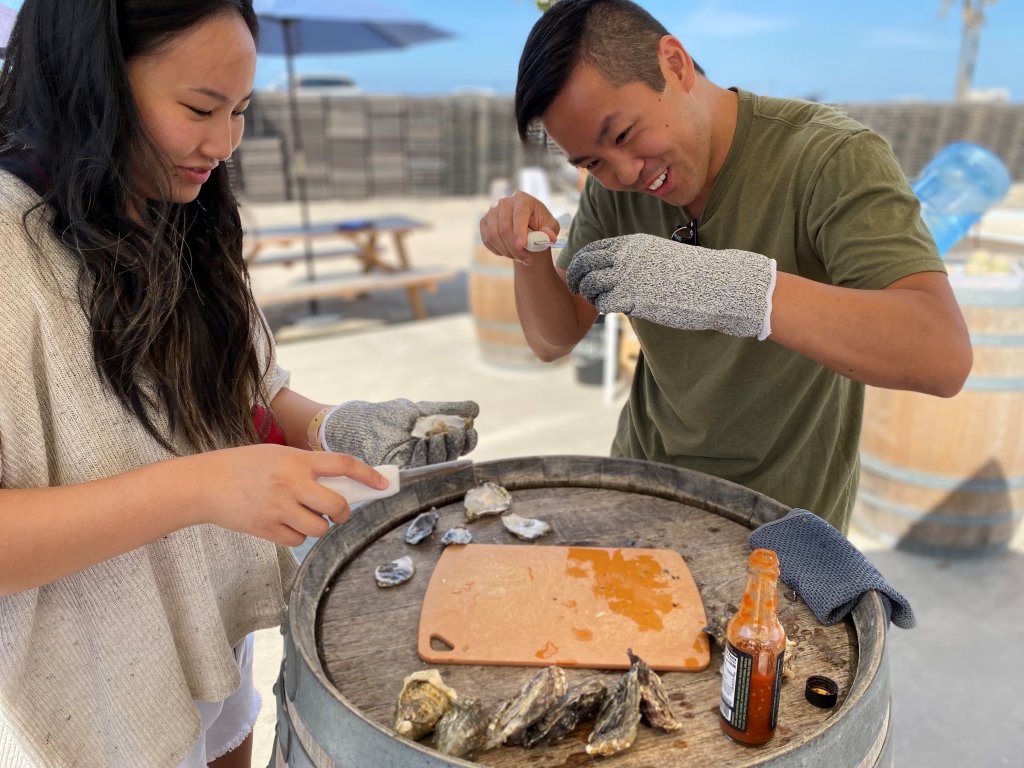 Kevin and Kimberly Leong learn how to shuck oysters. 