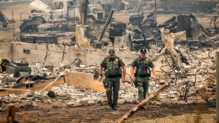 Sheriff's deputies leave a home where a McKinney Fire victim was found