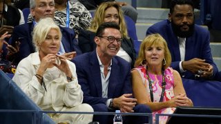 Hugh Jackman, center, watches Serena Williams, of the United States, and Danka Kovinic, of Montenegro, during the first round of the US Open tennis championships, Monday, Aug. 29, 2022, in New York.