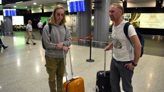Two Russian men arrive in Yerevan, Armenia, on September 21, 2022. Flights out of Russia were packed after Vladimir Putin introduced a partial draft of reservists to fight in Ukraine.