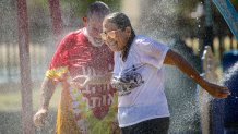 Ontario, CA - September 03: To beat  the brutal heat wave that is bearing down on Southern California, with temperatures expected to push into triple-digit temperatures through the Labor Day weekend, Aaron Zaretsky and wife Andrea Zaretsky enjoys cool water spray in the splash pad at Cucamonga-Guasti Regional Park on Saturday, Sept. 3, 2022 in Ontario, CA. (Irfan Khan / Los Angeles Times via Getty Images)