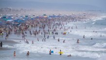 Huntington Beach, CA - September 04: Thousands of beach-goers flock to the beach and the cool ocean waters to escape the heat wave on Labor Day weekend in  Huntington Beach Sunday, Sept. 4, 2022. (Allen J. Schaben / Los Angeles Times via Getty Images)