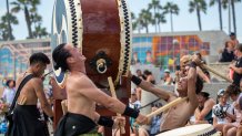 Huntington Beach, CA - September 04:  NOBUSHI, a professional taiko drum group from Fukuoka, Japan, performs before a crowd at the Pier Plaza Amphitheater while thousands of beach-goers flocked to the beach to escape the heat wave on Labor Day weekend in Huntington Beach on Sunday, Sept. 4, 2022. NOBUSHI translated means Wild Samurai, performs at concerts in Japan and around the world in stadiums and large theaters. (Allen J. Schaben / Los Angeles Times via Getty Images)