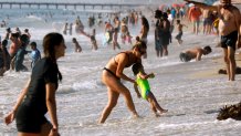 Hermosa Beach, Los Angeles, CaliforniaSept 5, 2022Jessica Cassata, center, and her daughter Camila Cassata, 16-months, cool off at Hermosa Beach, where they live. Los Angeles beaches drew a crowd on Labor Day, Sept. 5, 2022, with high temperatures through the region. (Carolyn Cole / Los Angeles Times via Getty Images)