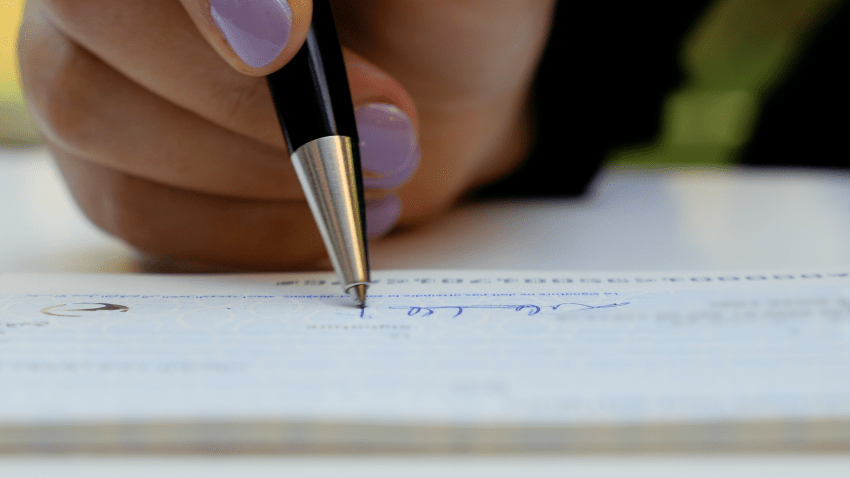 Here's What Color Ink You Should Use to Sign Your Checks to Avoid Fraud, According to BBB