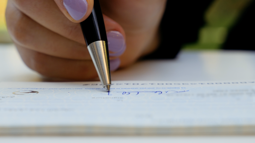 Here's What Color Ink You Should Use to Sign Your Checks to Avoid Fraud, According to BBB