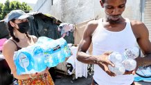 LOS ANGELES, CALIFORNIA - SEPTEMBER 04:  A member of the Skid Row community carries away water distributed by volunteers with Water Drop LA on September 4, 2022 in Los Angeles, California. Temperatures hovered around 100 degrees in downtown L.A. amid an intense heat wave in Southern California. Water Drop LA is a mutual aid organization which drops off 2,000 gallons of water each Sunday to members of the Skid Row community, many of who are suffering from water insecurity. Skid Row is home to thousands of people who either live on the streets or in shelters. The National Weather Service issued an Excessive Heat Warning for most of Southern California through September 7. Climate models almost unanimously predict that heat waves will become more intense and frequent as the planet continues to warm. (Photo by Mario Tama/Getty Images)