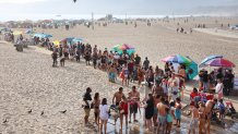 SANTA MONICA, CALIFORNIA - SEPTEMBER 04: People wait their turn to use a shower station on Santa Monica beach amid an intense heat wave in Southern California on September 4, 2022 in Santa Monica, California. The National Weather Service issued an Excessive Heat Warning for most of Southern California through September 7. Climate models almost unanimously predict that heat waves will become more intense and frequent as the planet continues to warm. (Photo by Mario Tama/Getty Images)