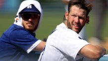 LOS ANGELES, CALIFORNIA - SEPTEMBER 07: Clayton Kershaw #22 and Cody Bellinger #35 of the Los Angeles Dodgers look out from the dugout during the sixth inning against the San Francisco Giants at Dodger Stadium on September 07, 2022 in Los Angeles, California. (Photo by Harry How/Getty Images)