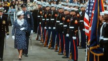 Queen Elizabeth II reviewing the guard of honour on February 26, 1983 at Broadway Pier, in San Diego, California, USA on arriving in the USA on board HMY Britannia. Walking behind her, is her Equerry, Squadron Leader Adam Wise. Queen Elizabeth II was on a Royal Tour of the USA.