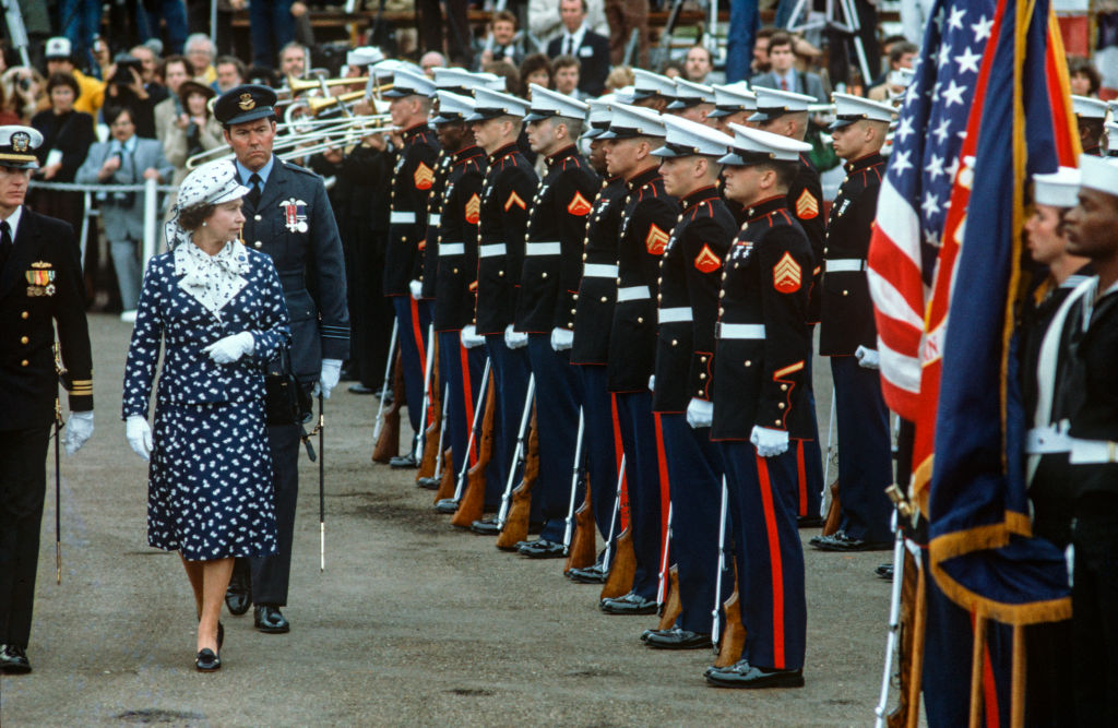 Queen Elizabeth II reviewing the guard of honour on February 26, 1983 at Broadway Pier, in San Diego, California, USA on arriving in the USA on board HMY Britannia. Walking behind her, is her Equerry, Squadron Leader Adam Wise. Queen Elizabeth II was on a Royal Tour of the USA.