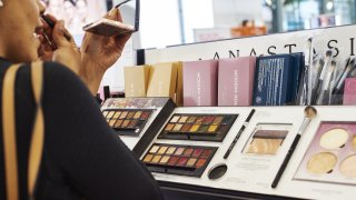 A customer applies Anastasia Beverly Hills eye shadow on display for sale at an Ulta Beauty Inc. store