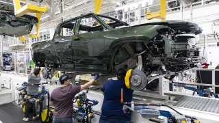 A Rivian R1T truck body lowered onto a chassis in the assembly line at the Rivian electric vehicle plant in Normal, Illinois. Georgia is giving the company $1.5 billion in subsidies to bring a new $5 billion EV plant to the southern state.