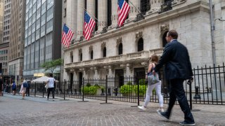 People walk outside of the New York Stock Exchange on July 25, 2022 in New York City.