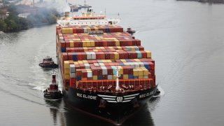 A cargo ship moves under the Bayonne Bridge as it heads into port on October 13, 2021 in Bayonne, New Jersey.