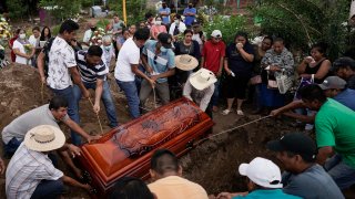 Residents bury Wilmer Rojas the day after he was killed in a mass shooting in San Miguel Totolapan, Mexico, Thursday, Oct. 6, 2022. Gunmen burst into a town hall meeting and shot to death 20 people, including a mayor and his father, officials said Thursday.