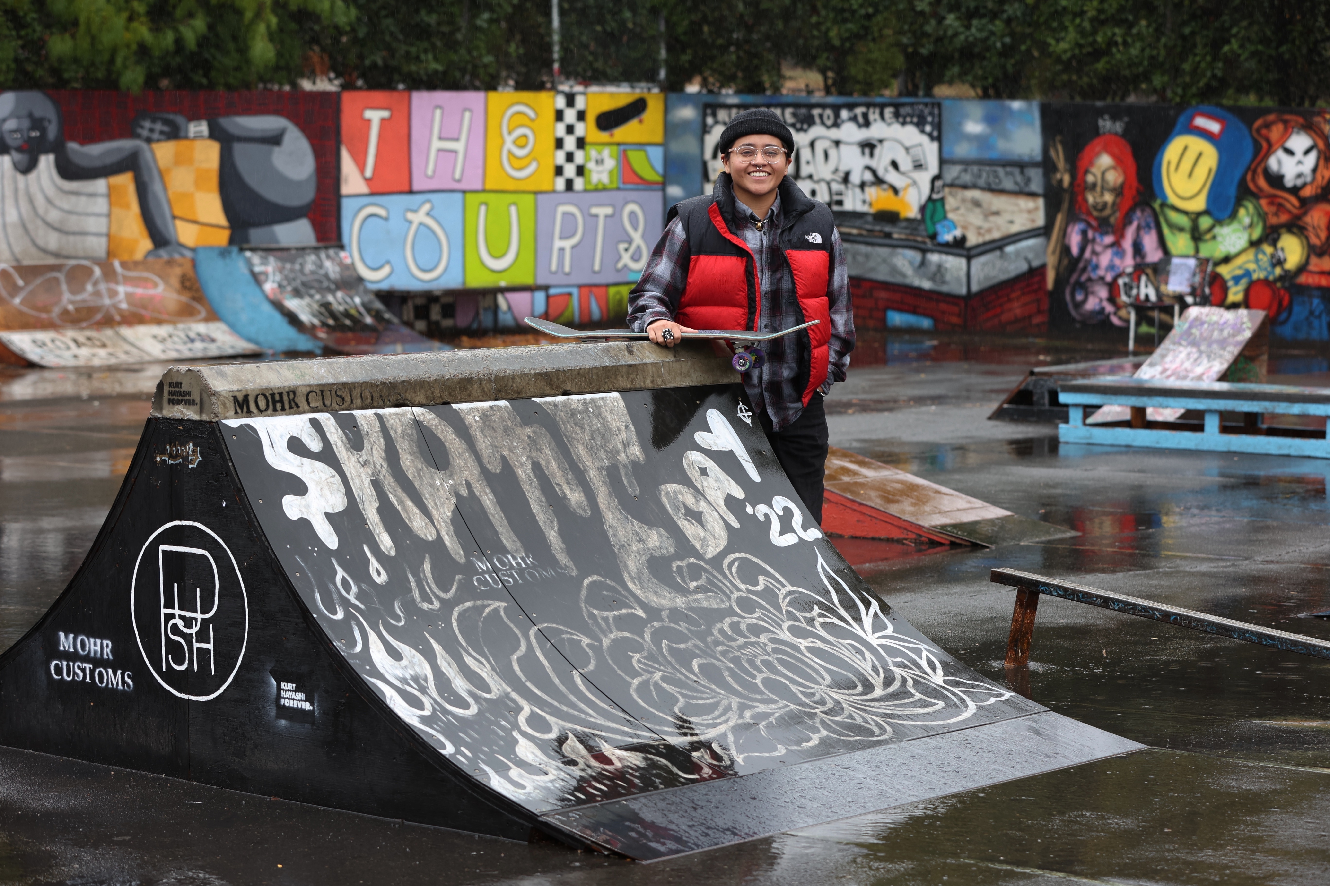 Sara Campos poses at tennis courts being converted to a skatepark