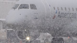 An American Eagle plane taxis during a snow storm at Seattle-Tacoma International Airport (SEA) in Seattle, Washington, US, on Tuesday, Dec. 20, 2022.