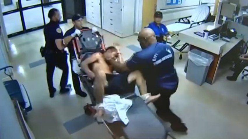 Miami Fire Lt. Robert Webster was caught on camera punching Antonio Cruz at Jackson Memorial Hospital.