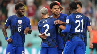 Weston McKennie of the United States celebrates with Sergino Dest during a FIFA World Cup Qatar 2022 Group B match between Iran and USMNT at Al Thumama Stadium on Nov. 29, 2022 in Doha, Qatar.