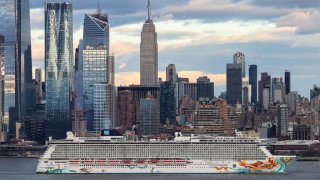 A Norwegian Gateway cruise ship leaves from the Manhattan port during sunset in New York City, United States on April 10, 2022.