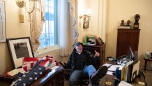 TOPSHOT - Richard Barnett, a supporter of US President Donald Trump sits inside the office of US Speaker of the House Nancy Pelosi as he protest inside the US Capitol in Washington, DC, January 6, 2021. - Demonstrators breeched security and entered the Capitol as Congress debated the a 2020 presidential election Electoral Vote Certification. 