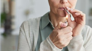Closeup of a mature woman smoking marijuana
