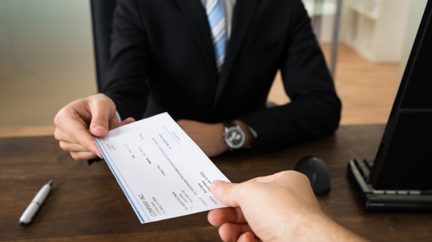 Someone being handed a paycheck,