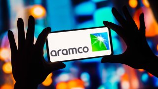 The Aramco logo is displayed on a smartphone screen.