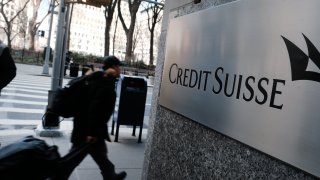 Credit Suisse announced late Wednesday it will be borrowing up to about $54 billion from Swiss National Bank. People walk by the New York headquarters of Credit Suisse on March 15, 2023 in New York City.