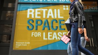 People walk by empty retail space in lower Manhattan on April 17, 2017 in New York City.