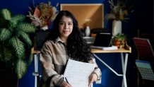 Priscilla Molina poses for a portrait in Los Angeles on Wednesday, Feb. 22, 2023. Molina designs a minimum of 300 custom signatures a month, offering packages that include up to three ways to sign, limitless drafts or a new set of initials. 