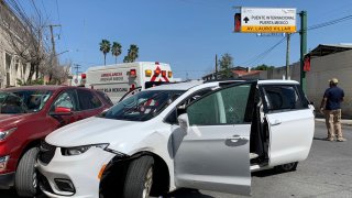 A member of the Mexican security forces stands next to a white minivan with North Carolina plates and several bullet holes, at the crime scene where gunmen kidnapped four U.S. citizens who crossed into Mexico from Texas, Friday, March 3, 2023.