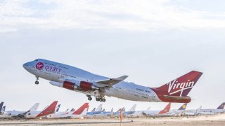 The modified 737 aircraft “Cosmic Girl” lifts off from Mojave Air and Space Port in California carrying a LauncherOne rocket on June 30, 2021.
