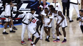 HOUSTON, TEXAS – APRIL 01: Lamont Butler #5 of the San Diego State Aztecs celebrates with teammates after making a game winning basket to defeat the Florida Atlantic Owls 72-71 during the NCAA Men’s Basketball Tournament Final Four semifinal game at NRG Stadium on April 01, 2023 in Houston, Texas. (Photo by Mike Lawrie/Getty Images)