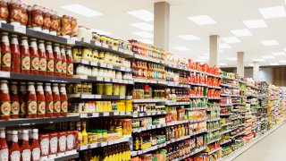 Stocked shelves in grocery store aisle