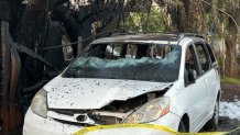 A van is left destroyed following a deadly house fire in El Cajon on Thursday, April 20, 2023.