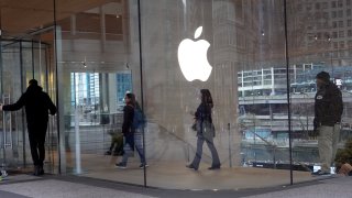Customers shop at an Apple store on November 28, 2022 in Chicago, Illinois.
