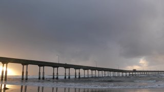 Ocean Beach pier in rainy weather, sea waves in rainfall, California coast, USA.